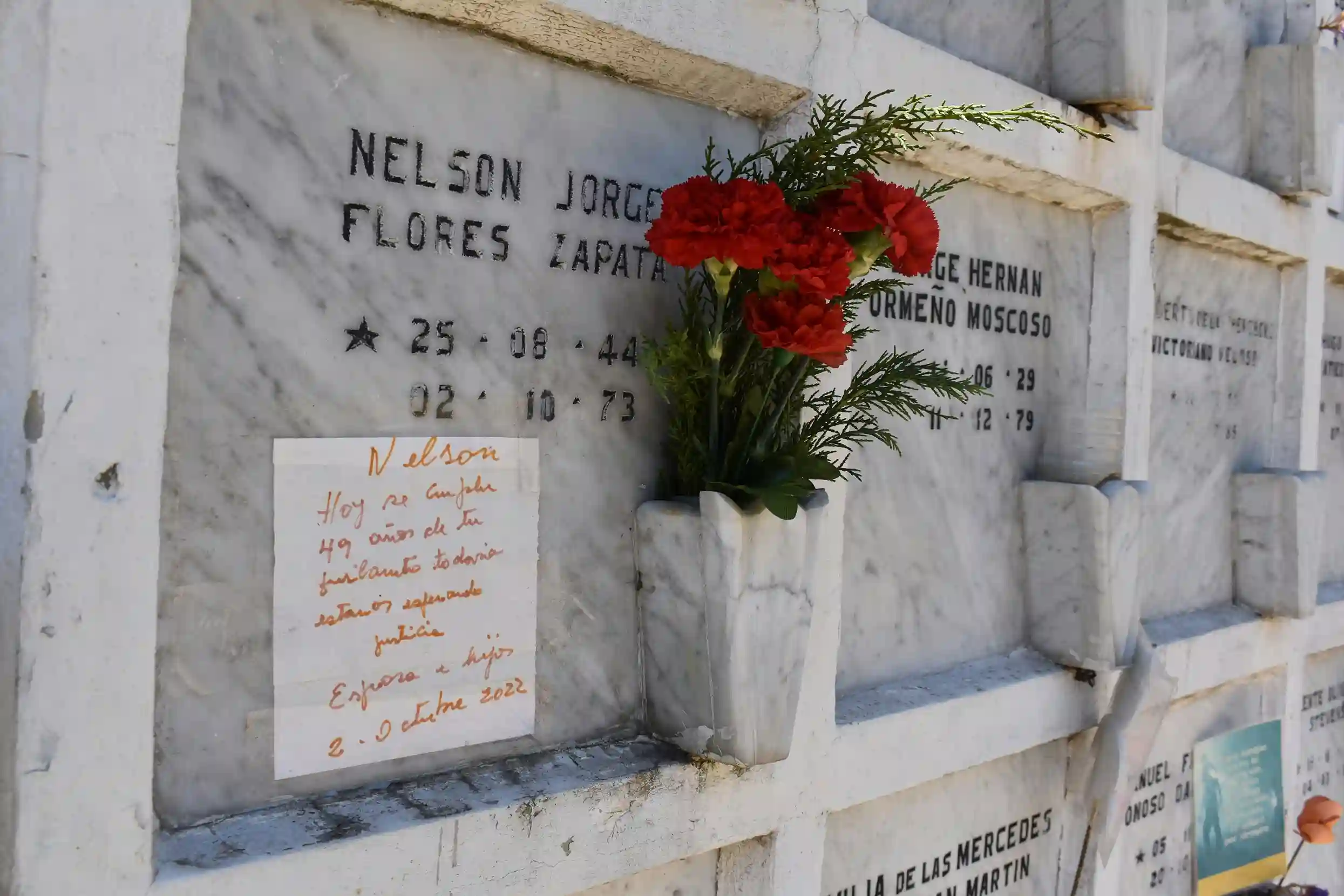 Flores sobre tumbas durante el Día de los Difuntos en Riobamba